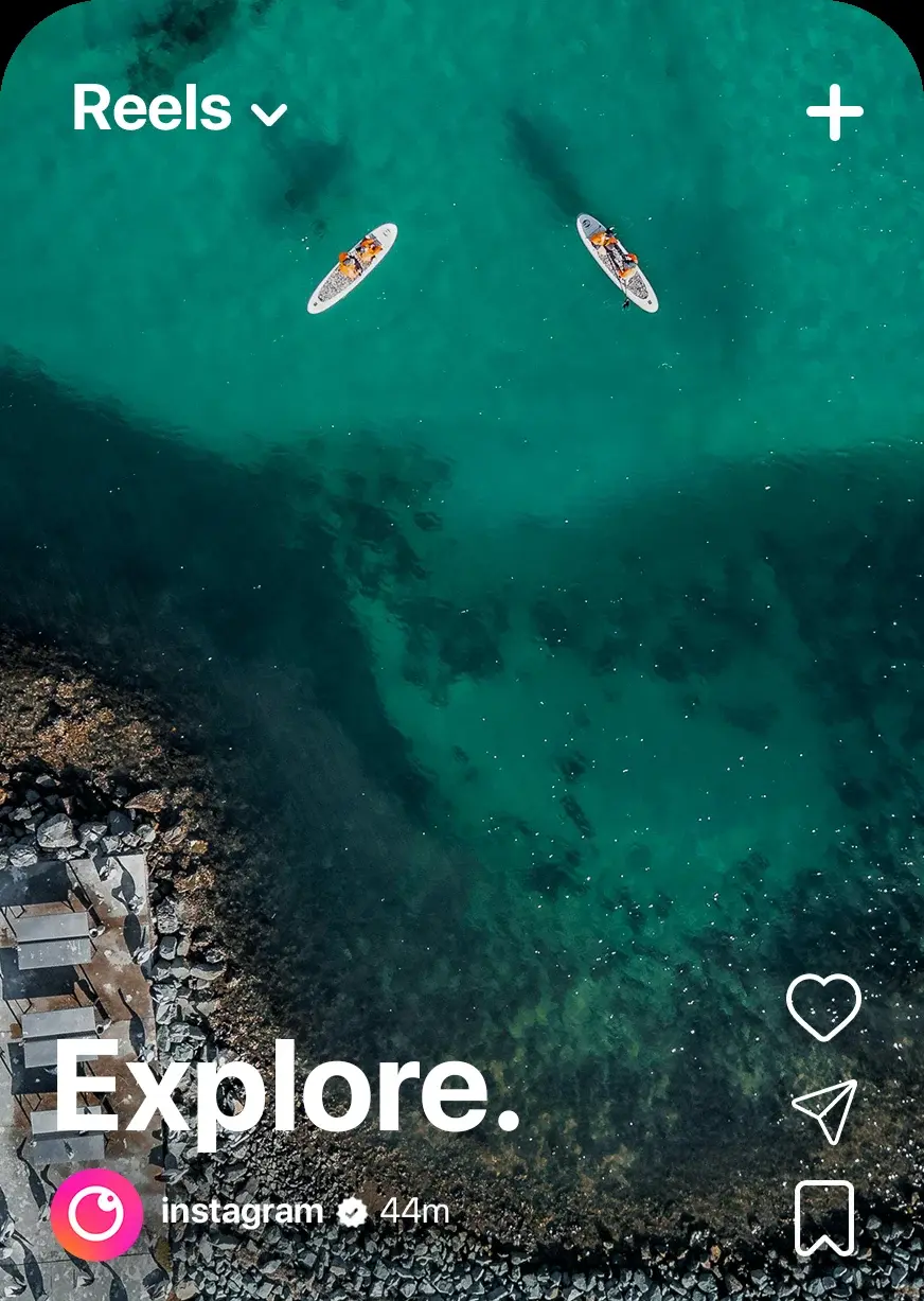 The reels feed with the new mark by the account name: an aerial shot of paddleboarders over clear water, captioned Explore