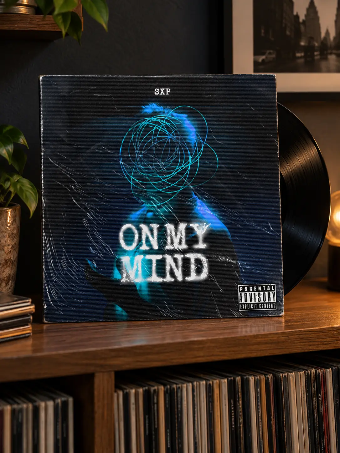 The On My Mind 12-inch sleeve standing on a low wooden record shelf against a dark wall, the edge of a black record showing.