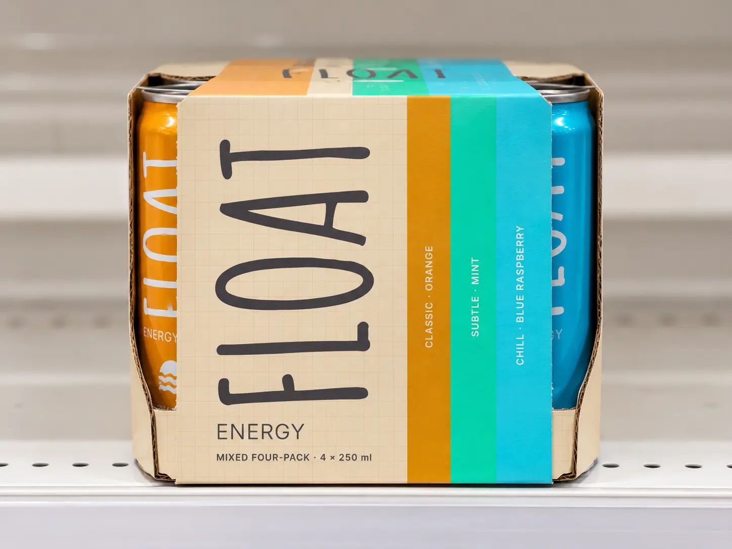 The mixed four-pack on a white supermarket shelf, its orange, mint and cyan stripes running up the side