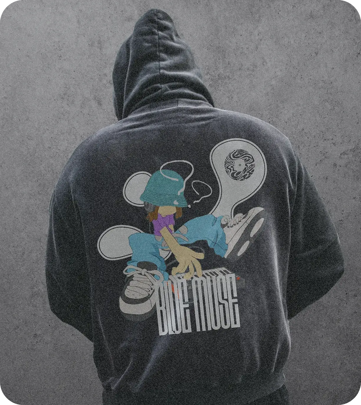 A washed charcoal hoodie from behind, printed with a character at a MIDI keyboard, two speech-bubble shapes, the mark and BLUE MUSE in tall letters.