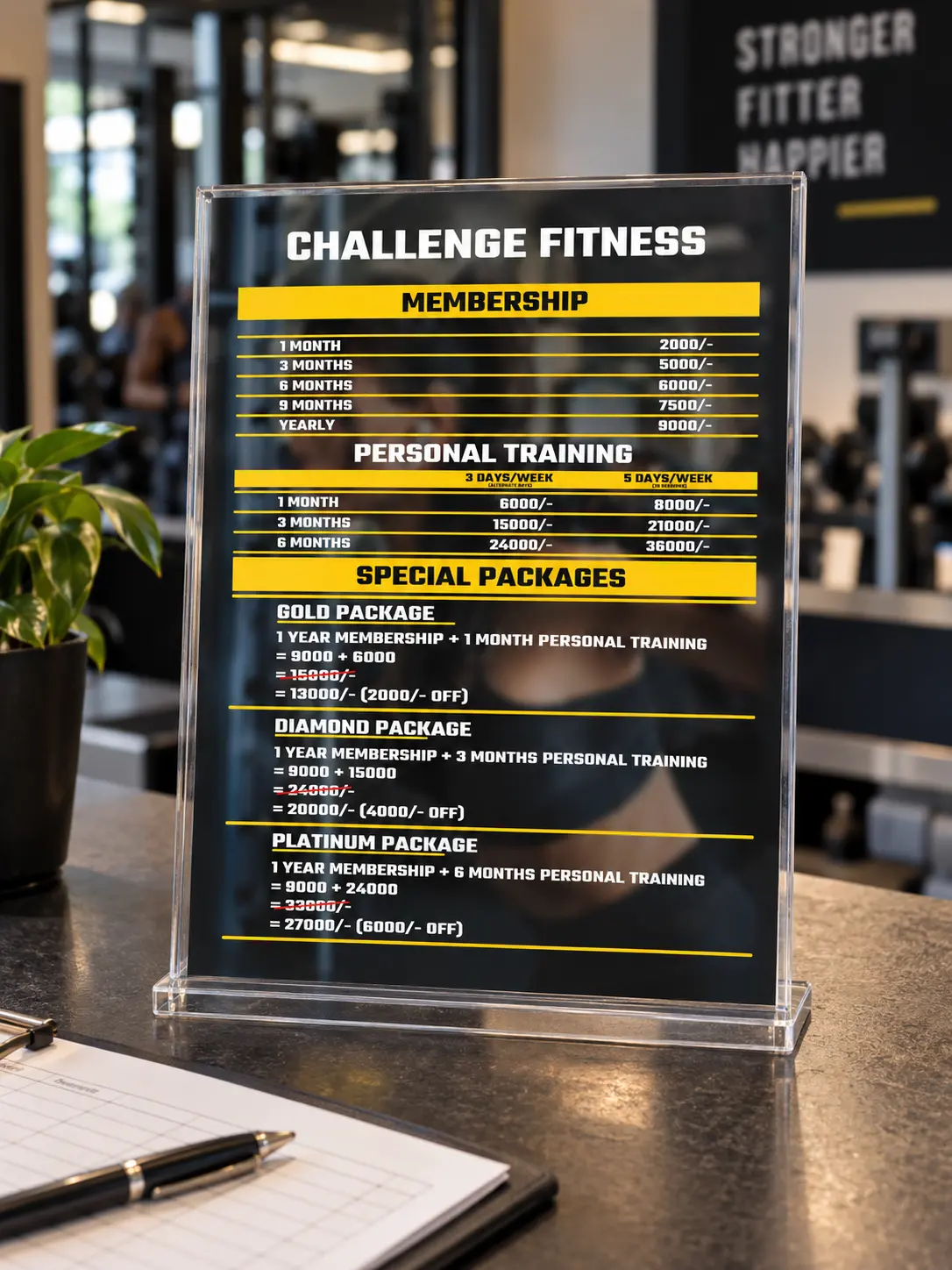 The price sheet in a clear stand on the gym's reception counter, beside a pen and a register